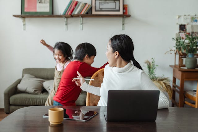 a woman and children playing in a room